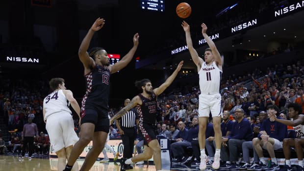 Virginia Cavaliers guard Isaac McKneely (11) shoots the ball over North Carolina Central Eagles guard Po'Boigh King (35) and Eagles forward Perry Smith Jr. (12) in the second half at John Paul Jones Arena. 